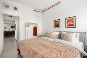 a bedroom with a large bed with white walls at  
