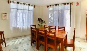 a dining room with a wooden table and chairs at Casa de Pablo in Puerto Ayora