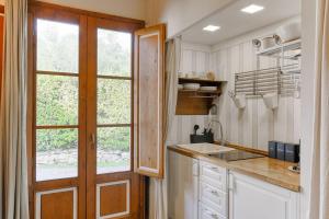 a kitchen with a sink and a window at Olive Garden Loft Relax among Olive Trees and Gazebos in Florence