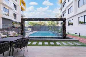 an outdoor patio with a swimming pool in a building at BMJ sleek homes in Nairobi