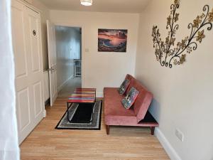 レディングにあるCozy Central One Bedroom Flatの赤いソファとテーブルのあるリビングルーム +22枚の写真