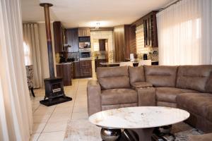 a living room with a couch and a table at Home Away Haven in Brakpan