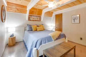 a bedroom with a bed and a wooden ceiling at 2 Mi to Smoky Mtns Natl Park! Hot Tub Hideaway in Townsend