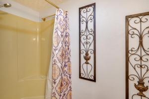 a bathroom with a shower curtain and a mirror at 2 Mi to Smoky Mtns Natl Park! Hot Tub Hideaway in Townsend +18 photos