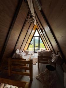 a attic room with two beds and a window at Vile NIT in Raška
