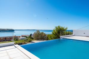 a swimming pool with a view of the water at Seaview Villa Summer with private pool & garden in Rtina