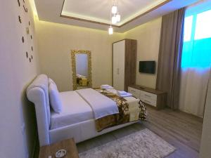 a bedroom with a large bed and a mirror at HOTEL St PAULI in Shkodër