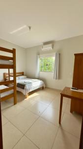 a bedroom with a bunk bed and a window at Pousada Marina do Farol in São José da Barra +36 photos