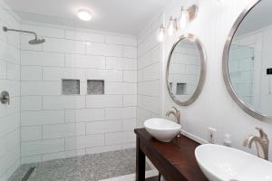 a white bathroom with a sink and a mirror at 559 Magnolia Ave in Demere Park +22 photos