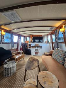 a living room with couches and tables in a boat at 43' Classic Trawler 5 Star Resort Pools, Views, Dining Free Shuttle to Downtown in Stock Island