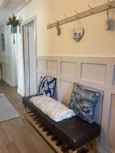 a bench sitting in a living room next to a wall at The Curracloe getaway in Curracloe