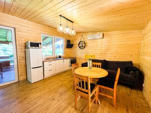 a kitchen and dining room with a table and a couch at Dom całoroczny in Kowal