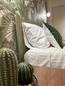 a room with a bed with pillows and a table at Room & Breakfast Olmo Tondo in San Giovanni in Persiceto +19 photos