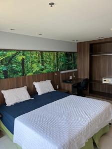 a bedroom with a bed with a desk and a window at Flat Studio - Hotel Style in Nova Iguaçu +13 photos