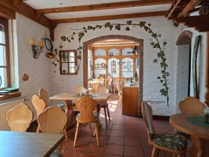 a restaurant with tables and chairs in a room at Haus Ambiente in Reil