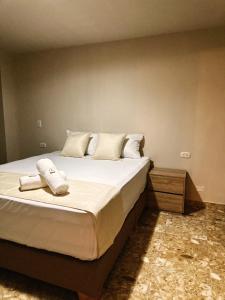 a bedroom with a large bed with towels on it at Hotel Bossanova in Rionegro