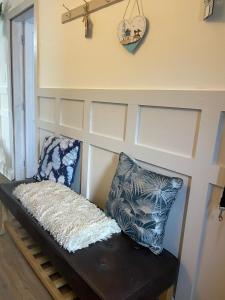 a bench in a room with two pillows on it at The Curracloe getaway in Curracloe
