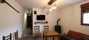 a living room with a couch and a table and chairs at Alpujarra Casa Fortuna in Mecina Fondales