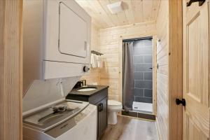 a small bathroom with a sink and a toilet at 2 Brand New Cabins For Family Retreat! in Sevierville +95 photos