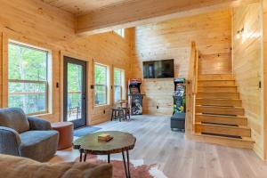 a large living room with wooden walls and a staircase at 2 Brand New Cabins For Family Retreat! in Sevierville