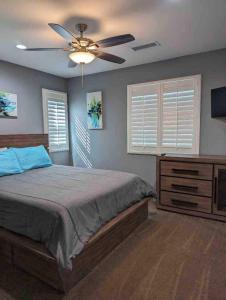 a bedroom with a bed and a ceiling fan at Alpine's Gorgeous Guest Home in Alpine