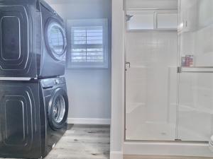 a washing machine in a bathroom with a window at Alpine's Gorgeous Guest Home in Alpine +16 photos