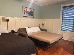a room with two beds and a couch and a window at Willow Lodge in Myrtle Beach +26 photos