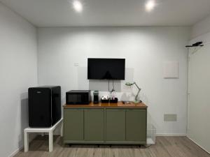 a room with a desk with a tv and a chair at DilettHouse vintage Apartment in Assemini