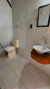 a bathroom with a sink and a toilet at Chalé Único in Alto Paraíso de Goiás