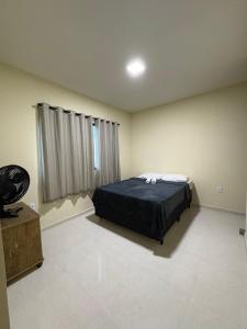 ein Schlafzimmer mit einem Bett und einem großen Fenster in der Unterkunft Refúgio do Mel - Piscina e Forno a Lenha in Gravatá + 16 Fotos