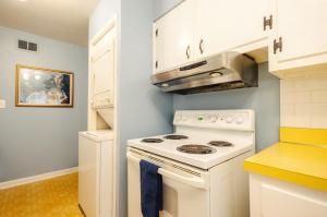 a kitchen with a white stove and a microwave at Centrally Located King Bed Midtown Memphis 2360 in Memphis +22 photos