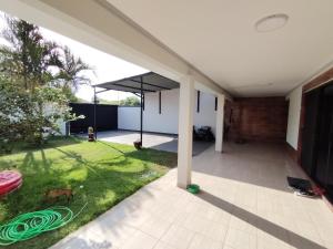 an open patio with a grassy yard in a house at SKk in Warnes +9 photos