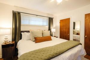 a bedroom with a large white bed and a window at Centrally Located King Bed Midtown Memphis 2360 in Memphis