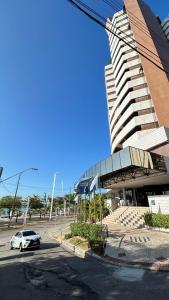 a car parked in a parking lot in front of a building at 1506 - Blue Tree Towers in Fortaleza