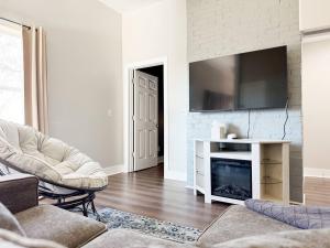 a living room with a fireplace and a tv at The Washington Apartments in Evansville