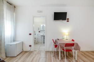 a dining room with a table and red chairs at Villa Trieste in Marghera