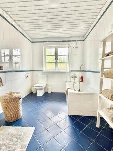a bathroom with a tub and a toilet and a sink at Casalot Almancil in Almancil