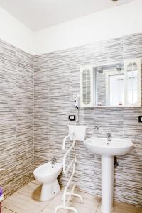 a bathroom with a sink and a toilet and mirror at Villa Trieste in Venice +37 photos