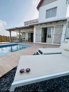 a pair of sunglasses sitting on a table in front of a house at Villa Mamina Martinique in Fort-de-France