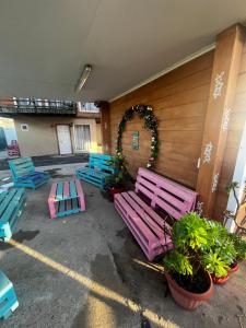 a group of colorful benches in front of a building at Habitación Rocas del mar in Pichilemu