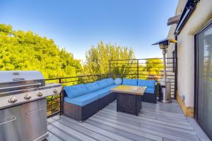 a patio with a couch and a grill on a balcony at Less Than 1 Mi to Santa Fe Plaza Mtn-View Gem with Hot Tub! in Santa Fe