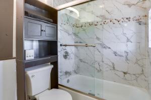 a bathroom with a toilet and a glass shower at Less Than 1 Mi to Santa Fe Plaza Mtn-View Gem with Hot Tub! in Santa Fe +26 photos