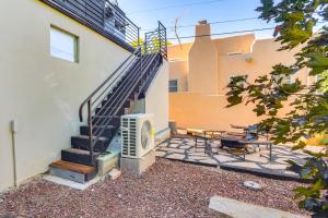 a patio with a staircase next to a building at Less Than 1 Mi to Santa Fe Plaza Mtn-View Gem with Hot Tub! in Santa Fe