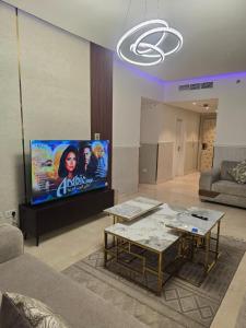 a living room with a couch and a tv at شقه بإطلاله للبحر داماك جدة in Jeddah