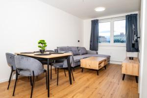 a living room with a table and a couch at Luxapartment l Krivá in Košice