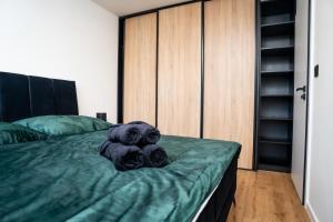 a teddy bear sitting on a bed in a bedroom at Luxapartment l Krivá in Košice