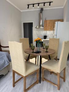 a kitchen and dining room with a wooden table and chairs at Квартиры апартаменты посуточно in Astana