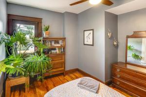 a bedroom with a bed and a dresser with plants at 6 Mi to Gambrill State Park Family Gem with Patio! in Frederick +20 photos