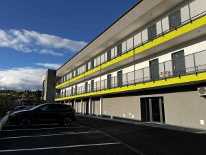 a black car parked in a parking lot in front of a building at BiQuarters in Košice