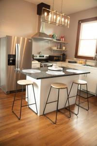 a kitchen with a island with three bar stools at 718 Morgan Ave in Harriman